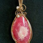 Dale Armstrong's Gem Profile- Rhodochrosite - , General Education, , Rhodochrosite pendant wrapped with gold filled wire