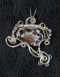 Judy Ellis's Gem Profile- Thundereggs and Mexican Lace Agate - , General Education, , Wire wrapped agate geode slice with silver wire 