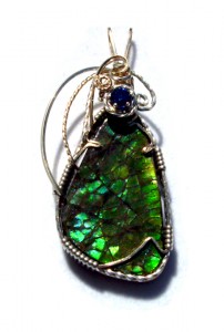 Dale Armstrong's Gem Profile- Ammolite - , General Education, , A freeform green ammolite cabochon with a sapphire accent